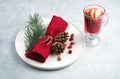 Christmas composition with a glass of mulled wine and a beautifully decorated plate with spruce branches and a red Royalty Free Stock Photo