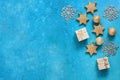 Christmas composition. Gold stars, balls, gift boxes and snowflakes on a blue rustic background. Top view, flat lay, copy space