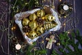 Christmas composition. Golden balls in a box, Christmas beads, garlands, candles in decorative candlesticks on a dark wooden Royalty Free Stock Photo