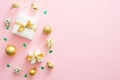 Christmas composition. Christmas golden decorations, gift boxes, baubles, confetti on pastel pink background with copy space. Flat Royalty Free Stock Photo