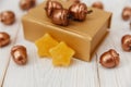 Christmas composition.Golden present box and golden acorns.White wooden table,jujube stars Royalty Free Stock Photo