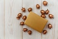 Christmas composition.Golden present box and golden acorns.White wooden table Royalty Free Stock Photo