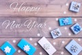 Christmas composition with the inscription Happy New Year. Gift boxes with bows and small decorative snowflakes are beautifully Royalty Free Stock Photo
