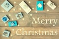 Christmas composition with the inscription Merry Christmas. White and blue gift boxes decorated with bows. Festive Royalty Free Stock Photo