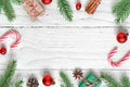 Christmas composition made of fir branches, decorations, berries, candy, gift boxes and pine cones. flat lay. top view Royalty Free Stock Photo