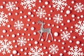 Christmas composition made of white snowflakes, deer on red background. New year winter minimal concept. Flat lay Royalty Free Stock Photo