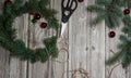 Making a wreath on the door of fir branches and willow twigs. Materials and tools, scissors and hemp rope on a wooden background.