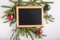 Christmas composition. New Year background. Festive xmas fir tree branches and blank chalkboard. Top view. Copy space Royalty Free Stock Photo