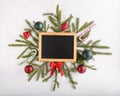 Christmas composition. New Year background. Festive xmas fir tree branches and blank chalkboard. Top view. Copy space Royalty Free Stock Photo