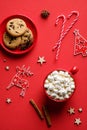 Christmas Composition With Oatmeal Cookies, Candy Canes, Cinnamon Sticks, Hot Chocolate On Red Background. Flat Lay, Top View