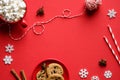 Christmas composition. Oatmeal cookies, hot chocolate with marshmallows, festive decorations on red background. Flat lay, top view