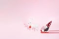 Christmas composition on a pastel pink background. Santa on a red sled and one white reindeer, red decoracion bauble. Xmas and Royalty Free Stock Photo