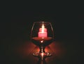 Christmas composition photo cognac glass and candle on black background Royalty Free Stock Photo