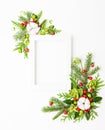 Christmas composition  with photo frame, cotton flower, branches of spruce and holly with red berries on white background. Merry Royalty Free Stock Photo