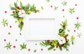 Christmas composition  with photo frame, cotton flower, branches of spruce and holly with red berries on white background. Merry Royalty Free Stock Photo