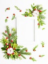 Christmas composition  with photo frame, cotton flower, branches of spruce and holly with red berries on white background. Merry Royalty Free Stock Photo