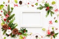 Christmas composition  with photo frame, cotton flower, branches of spruce and holly with red berries on white background. Merry Royalty Free Stock Photo