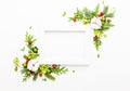 Christmas composition  with photo frame, cotton flower, branches of spruce and holly with red berries on white background. Merry Royalty Free Stock Photo