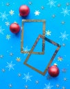 Christmas composition. Photo frames and red baubles on bright blue background. Royalty Free Stock Photo