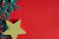 Christmas composition of pine cones, spruce branches and stack of gift boxes on red background