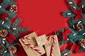 Christmas composition of pine cones, spruce branches and stack of gift boxes on red background Royalty Free Stock Photo