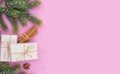 Christmas composition on pink background with gift box and anise star and cinnamon bundle Royalty Free Stock Photo