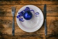 Christmas composition with plate, knife, fork, blue new year ball