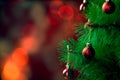 Christmas composition. Red balls on a Christmas tree on a red background with bokeh