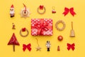 Christmas composition. Red christmas gift and many retro christmas ornaments isolated on bright yellow background. Royalty Free Stock Photo