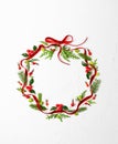 Christmas composition  with red ribbon, branches of spruce and holly with red berries in shape of Christmas bauble on white Royalty Free Stock Photo