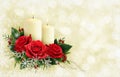 Christmas composition with red rose flowers and candles on holiday background