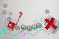 Christmas composition of red and silver decorations, gift box with ribbon bow, flatlay Royalty Free Stock Photo