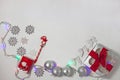 Christmas composition of red and silver decorations, gift box with ribbon bow, flatlay Royalty Free Stock Photo