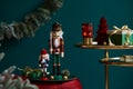 Christmas composition on the red velvet bench with decoration, gifts, wreath, nutcracker and accessories. Royalty Free Stock Photo