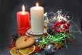 Christmas composition: red and white burning candles on a festive table on a dark background. Gingerbread, tinsel, festoon. Royalty Free Stock Photo