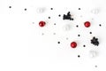 Christmas composition. Red and white Christmas glass balls, baubles, silver confetti stars and black privet, Ligustrum Royalty Free Stock Photo