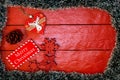 Christmas composition on red wooden board with Christmas garland and decorations. Creative composition with border and copy space Royalty Free Stock Photo