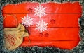 Christmas composition on red wooden board with Christmas garland and decorations. Creative composition with border and copy space Royalty Free Stock Photo