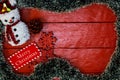 Christmas composition on red wooden board with Christmas garland and decorations. Creative composition with border and copy space Royalty Free Stock Photo