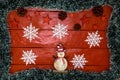 Christmas composition on red wooden board with Christmas garland and decorations. Creative composition with border and copy space Royalty Free Stock Photo