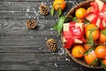 Christmas composition with ripe tangerines, gift boxes and space for text on wooden background Royalty Free Stock Photo