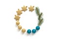 Christmas composition, round frame of gold and blue Christmas balls, stars and fir branches on a white background. Top view, flat Royalty Free Stock Photo