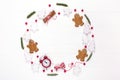 Christmas composition. Round frame made of decorations, fir tree branches, gingerbread man cookies on white background. Winter ho Royalty Free Stock Photo