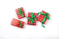 Christmas composition. Rred gift boxes with green ribbon at white background. Red christmas baubles. Merry Christmas greeting card