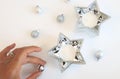 Christmas Composition of Silver Ornaments and Silver Star Candle Decoration