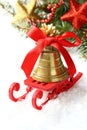 Christmas composition with sleigh and golden bell over white Royalty Free Stock Photo