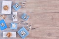 Christmas composition. Small blue and white gift boxes with bows, spirals of ribbons. Empty wooden background. Royalty Free Stock Photo