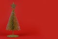 Christmas composition. small Christmas tree on a red background. New Year concept