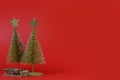 Christmas composition. small Christmas tree on a red background. New Year concept