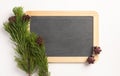 Christmas composition. Spruce branches and blank blackboard, on a white background Royalty Free Stock Photo